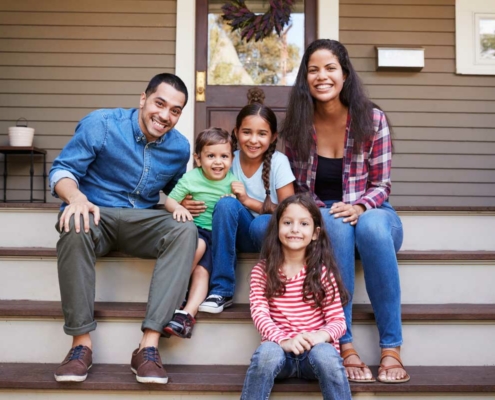 Happy family sitting on the front porch